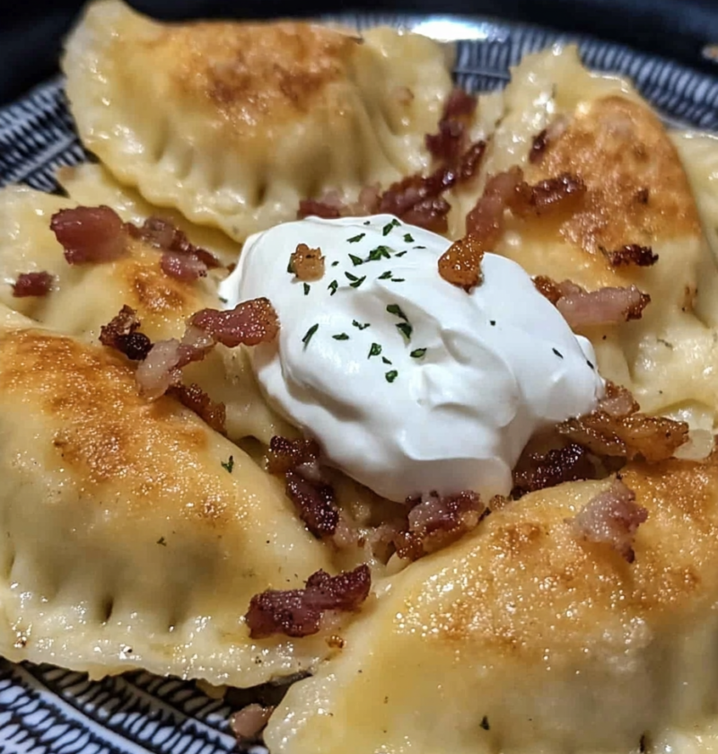 Homemade pierogi with bacon onion and sour cream
